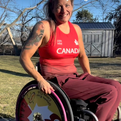Brianna Hennessy in her wheelchair with 'Team Canada' wheel cover showing